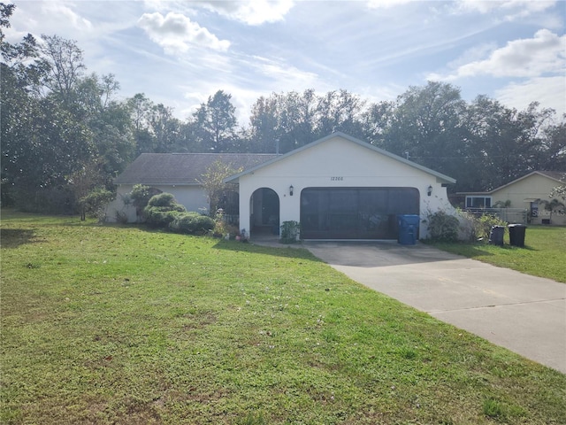 ranch-style house featuring a front lawn and a garage