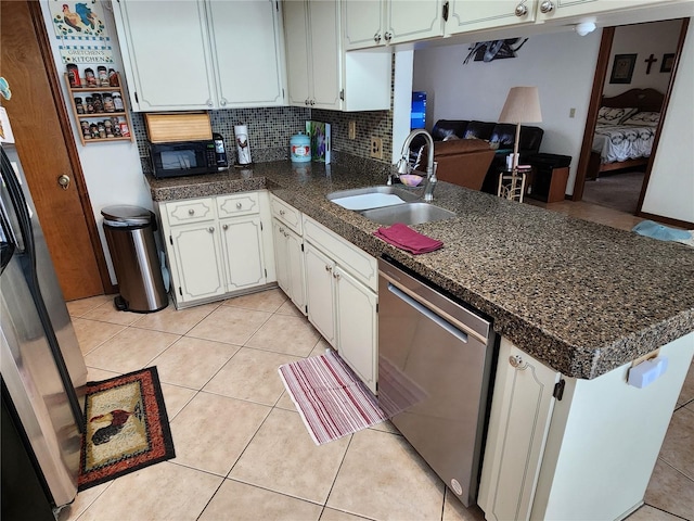 kitchen with dishwasher, sink, kitchen peninsula, decorative backsplash, and white cabinets