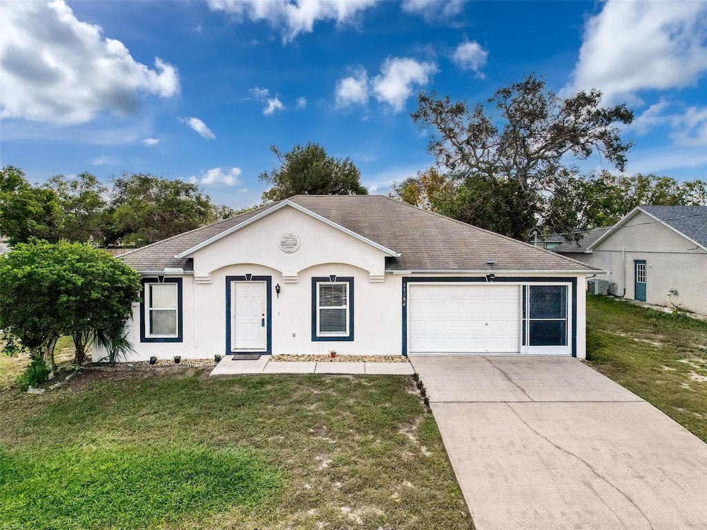 ranch-style house with a garage and a front yard