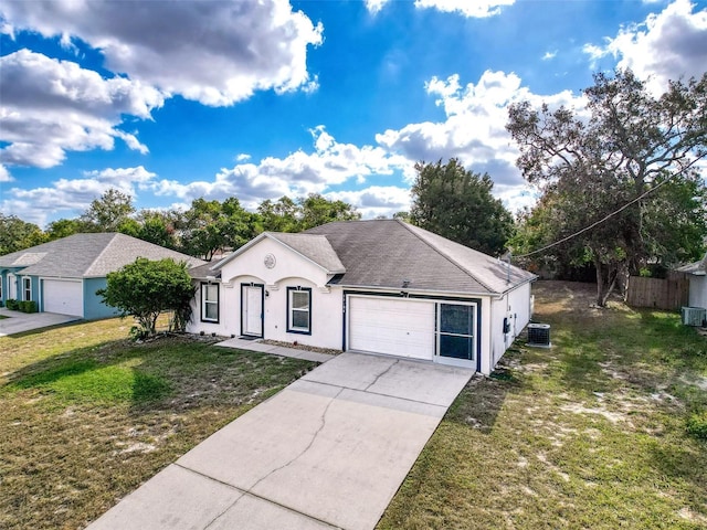 view of front of home with a garage, a front lawn, and cooling unit