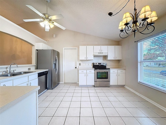 kitchen with lofted ceiling, sink, a textured ceiling, appliances with stainless steel finishes, and white cabinetry