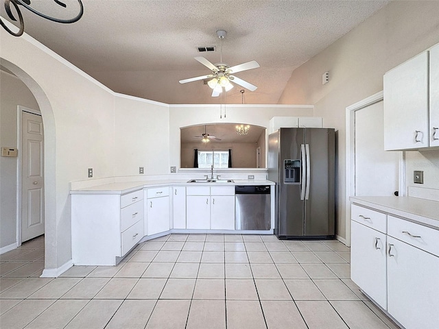 kitchen featuring sink, white cabinets, stainless steel appliances, and vaulted ceiling