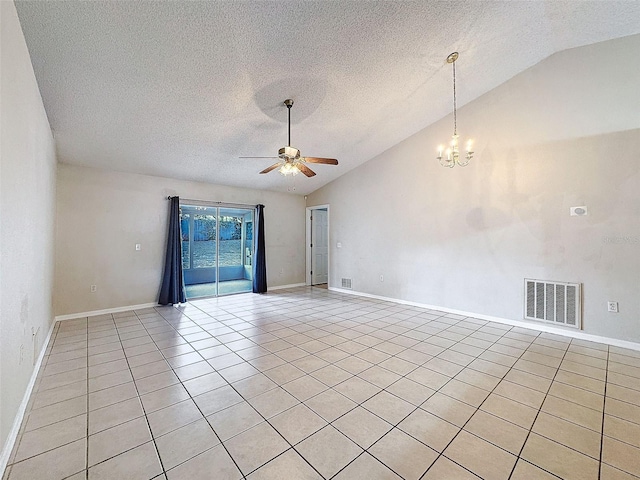 tiled empty room featuring ceiling fan with notable chandelier, a textured ceiling, and lofted ceiling