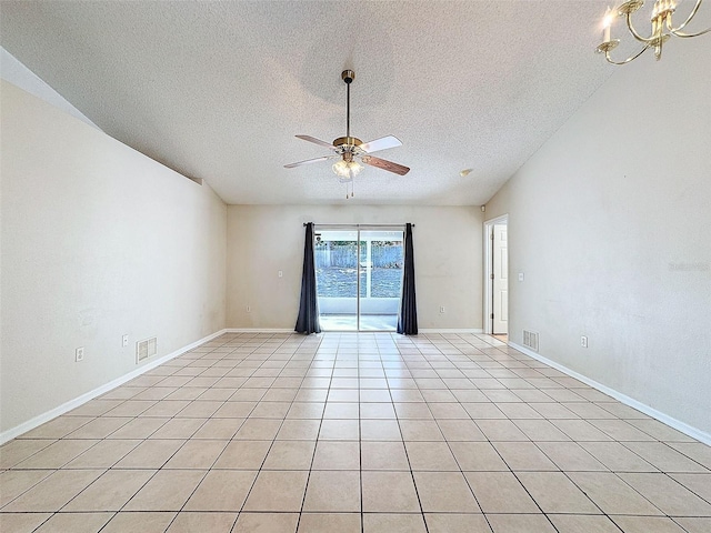 unfurnished room with ceiling fan with notable chandelier, light tile patterned floors, and a textured ceiling