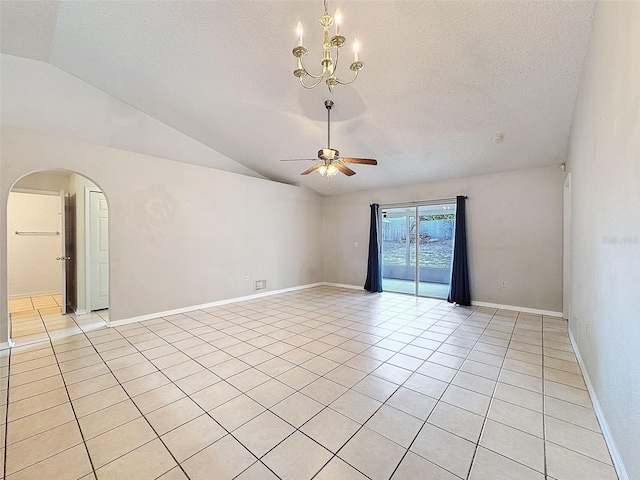 empty room with ceiling fan with notable chandelier, light tile patterned floors, a textured ceiling, and vaulted ceiling