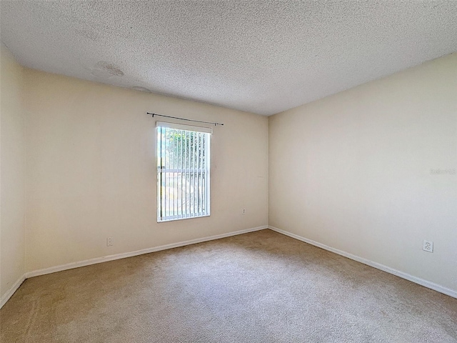 unfurnished room featuring carpet floors and a textured ceiling