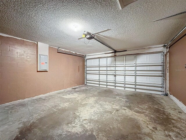 garage with electric panel and a garage door opener