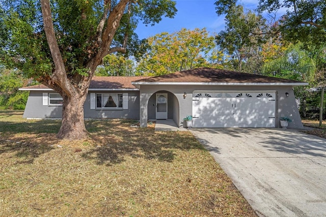 ranch-style house with a front yard and a garage