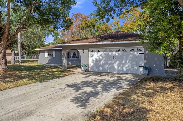 single story home with a front yard and a garage