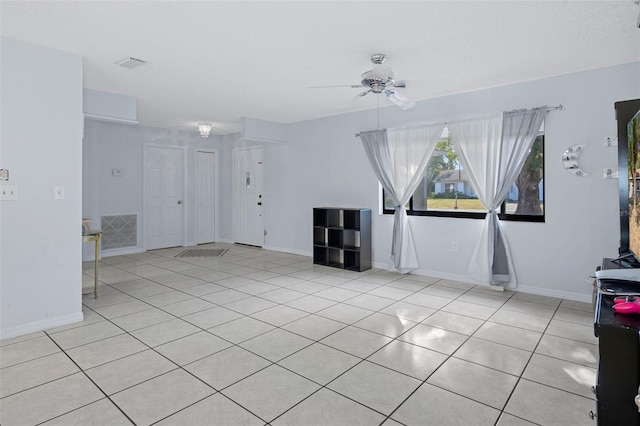 unfurnished living room featuring ceiling fan and light tile patterned floors