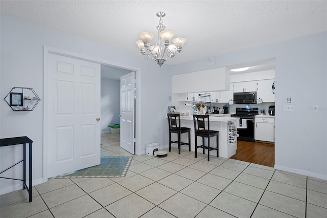 kitchen with white cabinetry, an inviting chandelier, black range with electric cooktop, kitchen peninsula, and decorative light fixtures