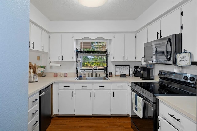 kitchen featuring dark hardwood / wood-style flooring, a textured ceiling, sink, black appliances, and white cabinetry