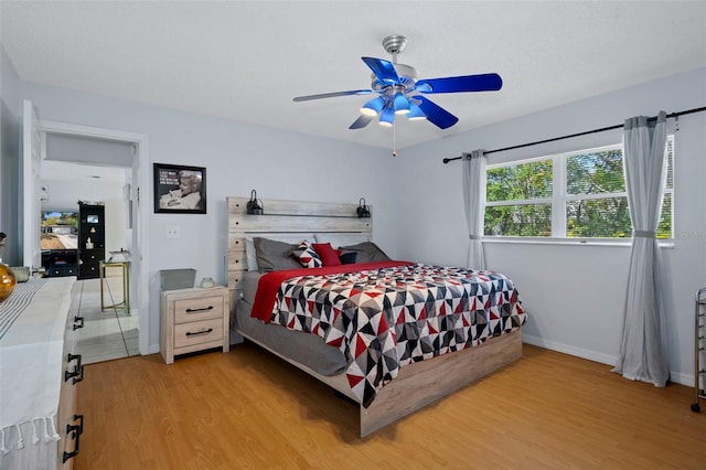 bedroom featuring ceiling fan and light hardwood / wood-style flooring