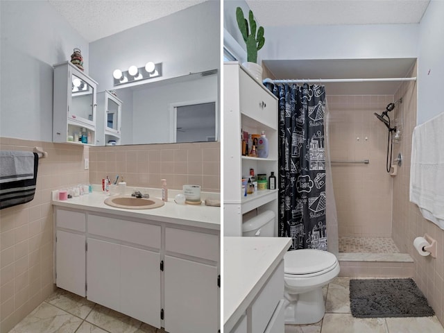 bathroom featuring vanity, a textured ceiling, a shower with shower curtain, and tile walls