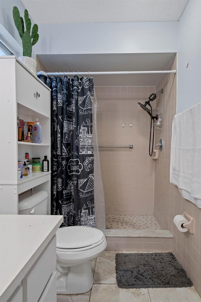 bathroom featuring a shower with shower curtain, vanity, toilet, and tile patterned flooring