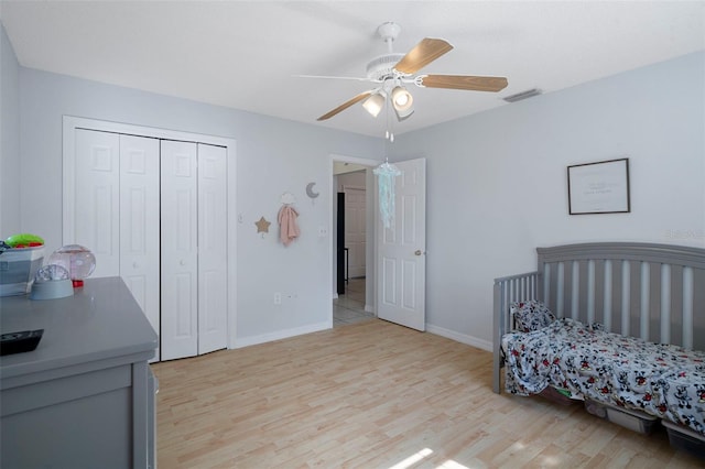 bedroom with a closet, light hardwood / wood-style flooring, and ceiling fan