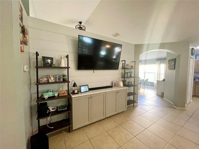 living room featuring light tile patterned floors and vaulted ceiling