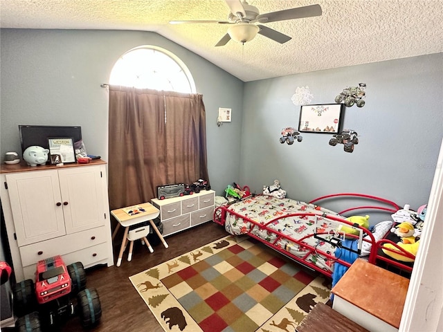 bedroom featuring ceiling fan, dark hardwood / wood-style flooring, lofted ceiling, and a textured ceiling