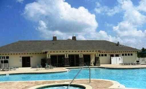 view of pool with a patio area and a community hot tub