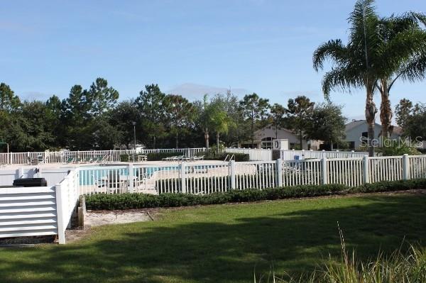 view of pool with a lawn