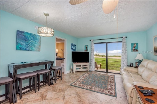 living room with tile patterned floors and ceiling fan