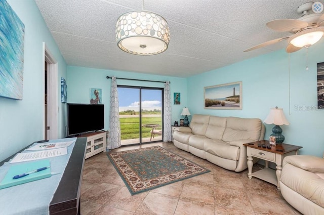 tiled living room featuring ceiling fan and a textured ceiling