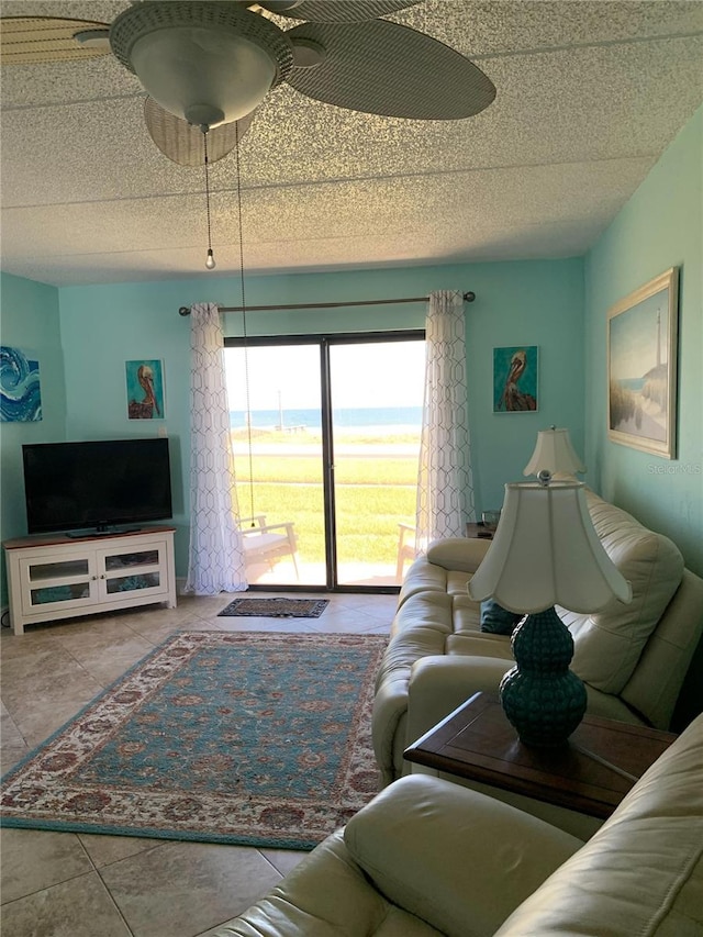 tiled living room featuring ceiling fan