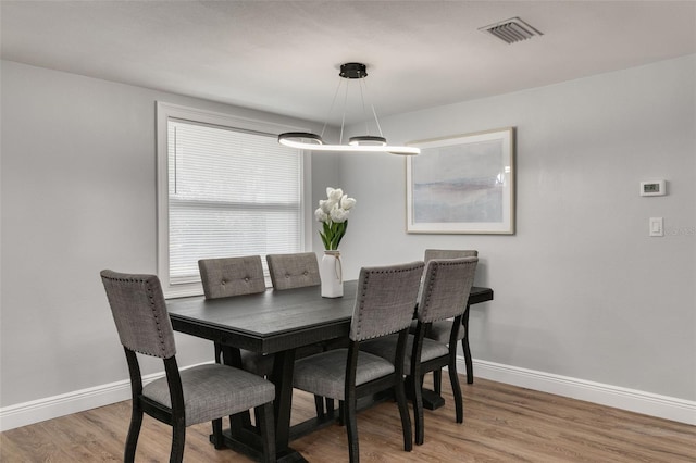 dining space with hardwood / wood-style flooring