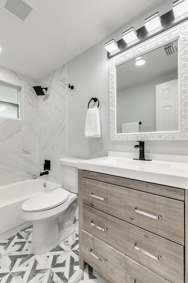 full bathroom with vanity, toilet, and tiled shower / bath