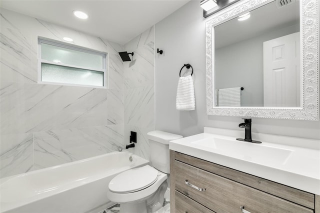 full bathroom with vanity, tiled shower / bath combo, and toilet