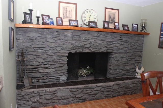 details with a fireplace with raised hearth and wood finished floors