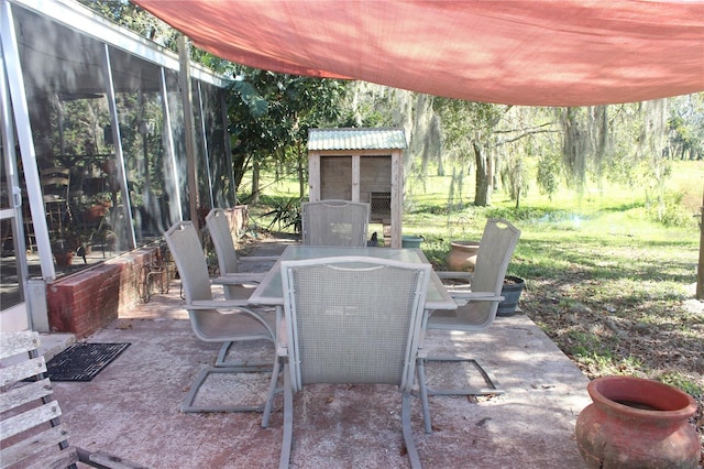 view of patio featuring an outbuilding and outdoor dining space