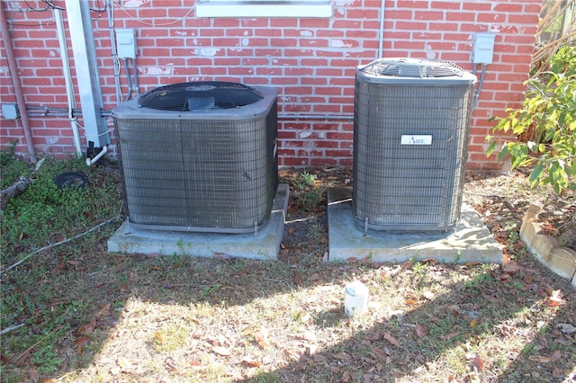 details with central air condition unit and brick siding