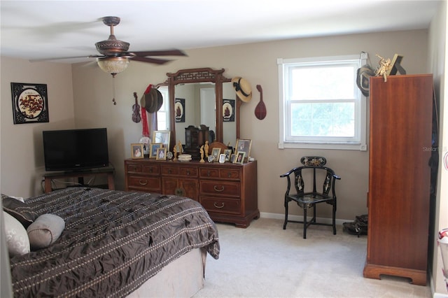 bedroom featuring light carpet and baseboards