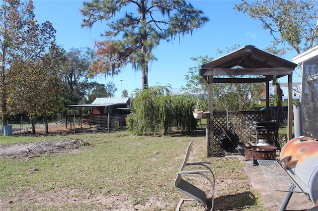 view of yard with an outbuilding and fence