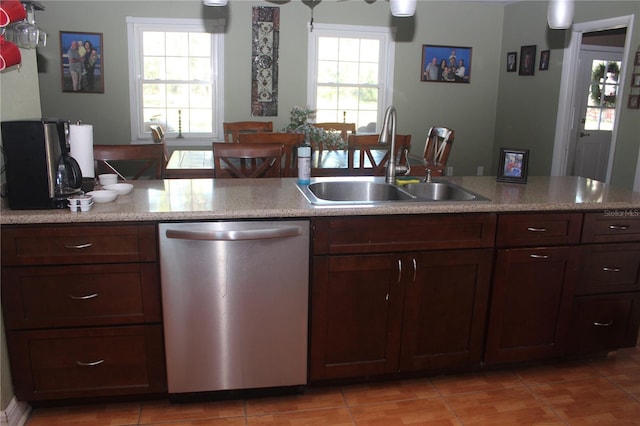 kitchen with dishwasher, light tile patterned flooring, and a sink