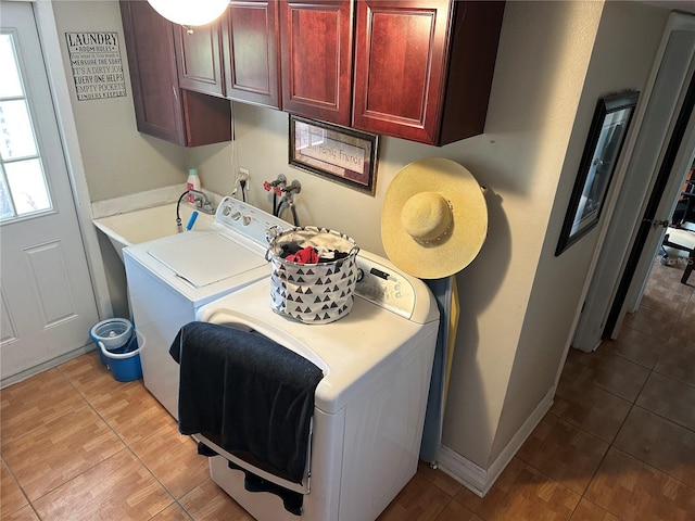 laundry area featuring cabinet space, baseboards, and separate washer and dryer