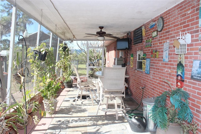 unfurnished sunroom featuring ceiling fan