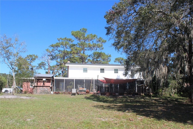 back of property with a lawn