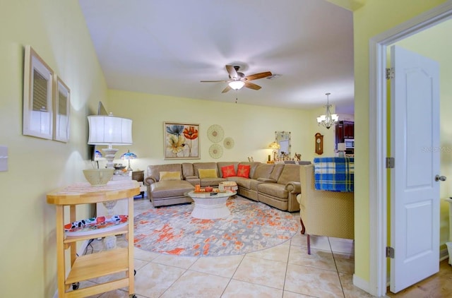 living room featuring ceiling fan with notable chandelier and light tile patterned flooring