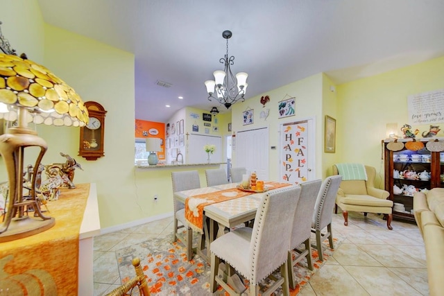 tiled dining room featuring sink and an inviting chandelier