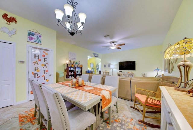 dining area with light tile patterned floors and ceiling fan with notable chandelier