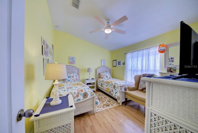 bedroom with ceiling fan, wood-type flooring, and vaulted ceiling