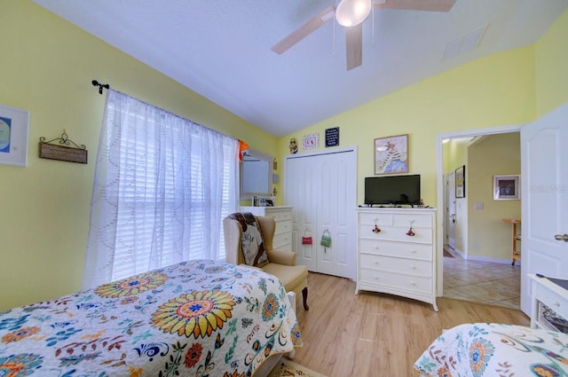 bedroom featuring ceiling fan, a closet, lofted ceiling, and light hardwood / wood-style flooring