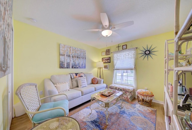 living room featuring light wood-type flooring and ceiling fan