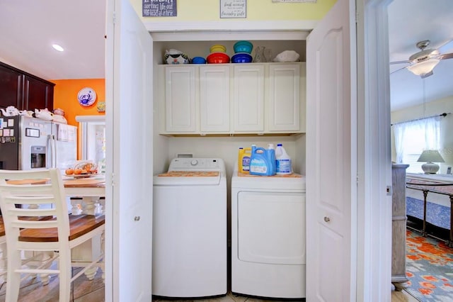 laundry area featuring washer and dryer, ceiling fan, and cabinets