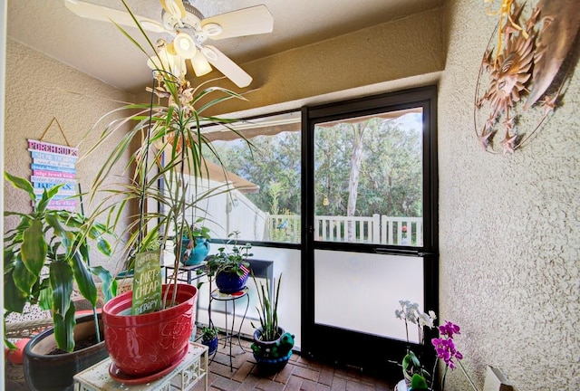 sunroom / solarium with ceiling fan