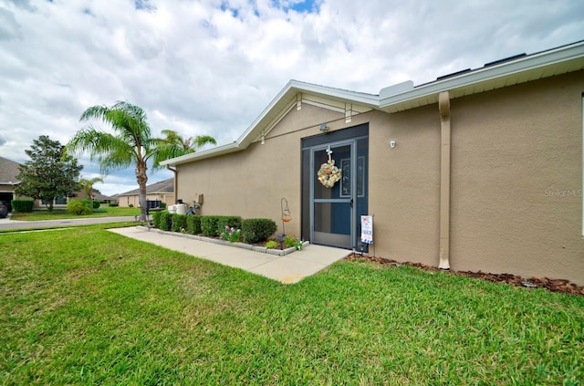 property entrance with a yard