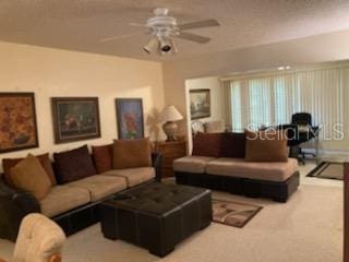 carpeted living room featuring ceiling fan