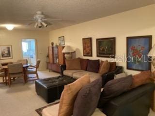 living room featuring ceiling fan and carpet floors